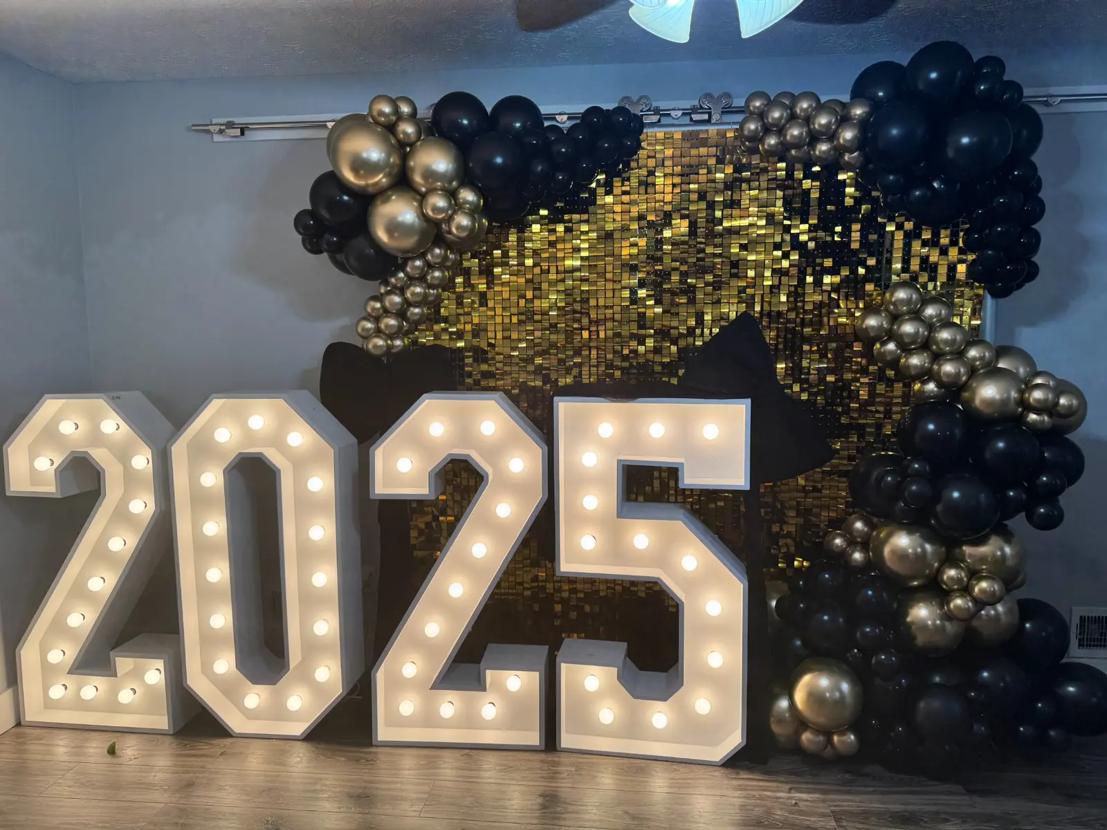 2025 marquee numbers with black and gold balloons