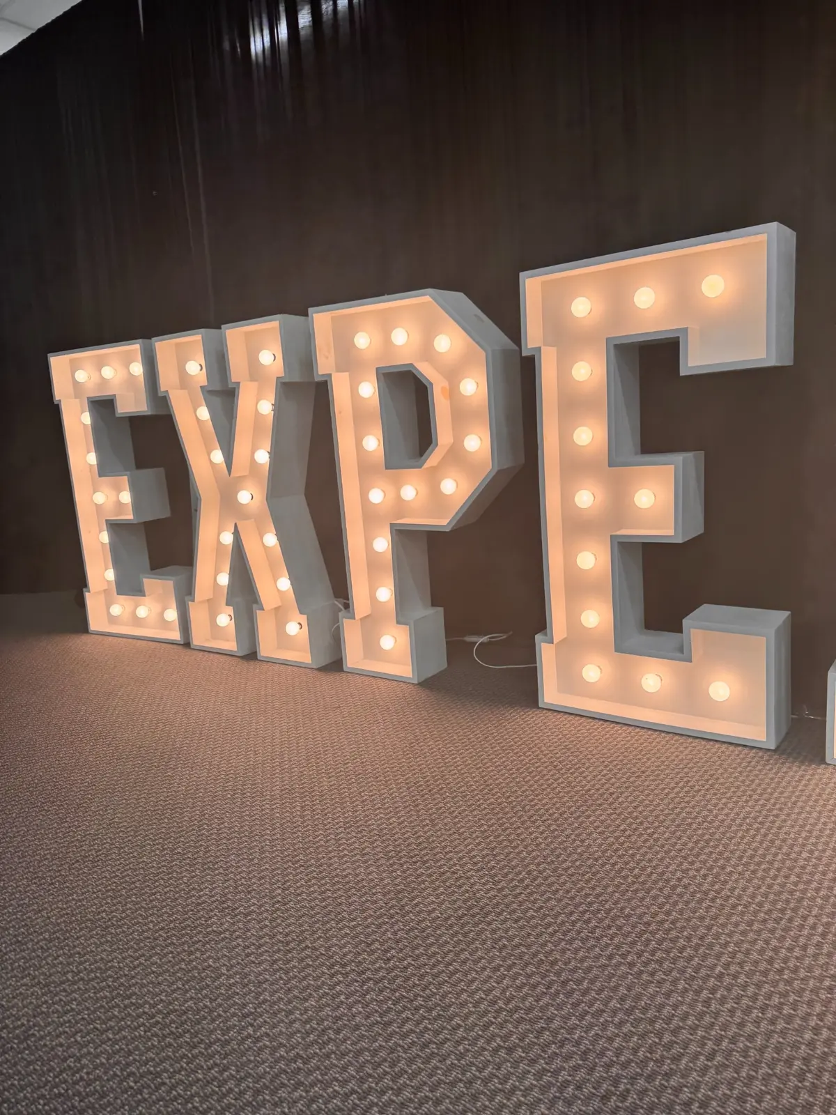 Four illuminated marquee letters