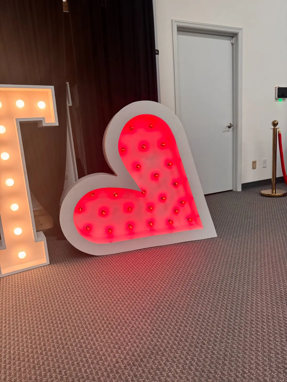 Illuminated heart marquee at an indoor event